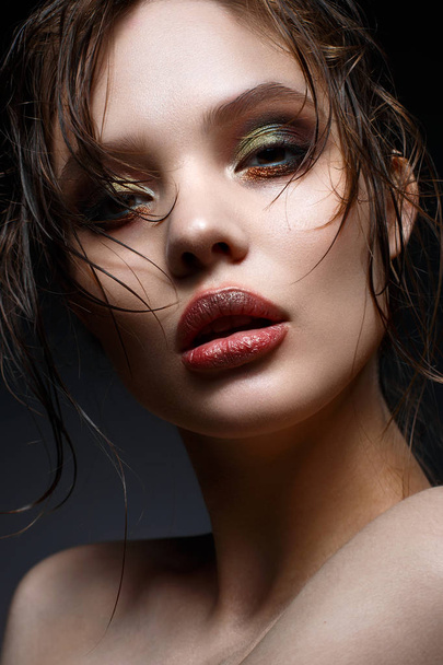 A young girl with bright creative makeup and perfect skin. Beautiful model with wet hair on face.  - Zdjęcie, obraz