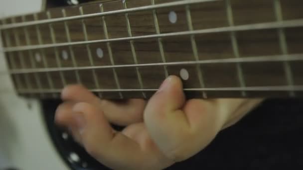 Mężczyzna gra gitara basowa zbliżenie - Materiał filmowy, wideo
