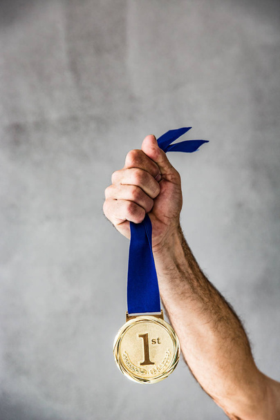 man holding medal in hand. - Фото, зображення