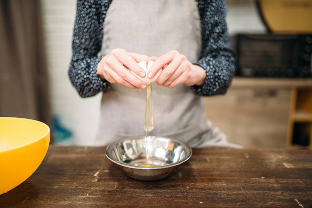 woman breaking egg into bowl  - Photo, Image