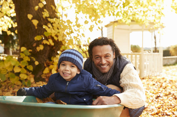 Father and Son In Autumn Garden - Photo, Image