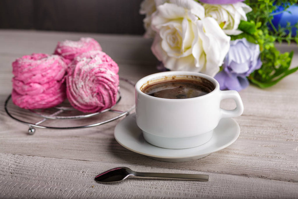Black coffee and pink zephyr. marshmallow. Sweet pink marshmallow - zephyr and cup of Coffee. Christmas Still Life. Winter drink theme. Romance. Provencal still life. Good morning - Photo, Image