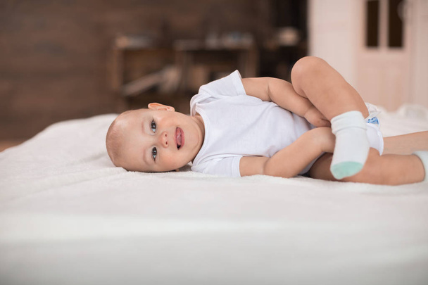 Cute baby boy on bed - Foto, immagini