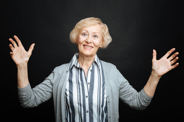 Delighted old woman expressing emotions in the studio - Fotoğraf, Görsel