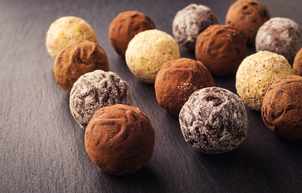 Chocolate truffle,Truffle chocolate candies with cocoa powder.Chocolate candies collection.Assorted chocolate truffles with cocoa powder, coconut and chopped hazelnuts on a dessert plate. - Photo, Image