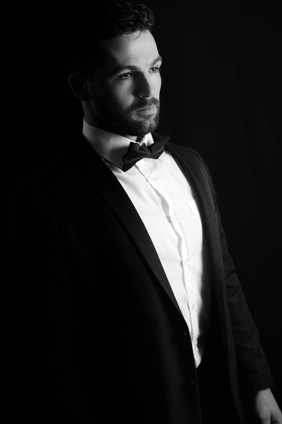 Black and white photography of a man wearing a tuxedo  - Fotó, kép