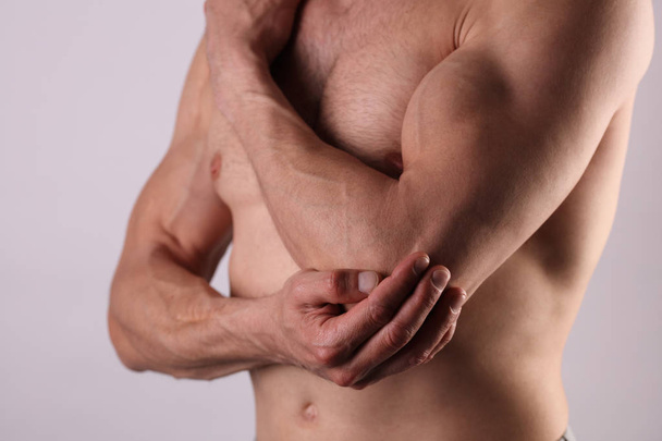 Man With Pain In Elbow. Pain relief concept - Fotó, kép