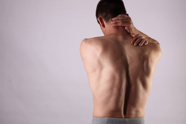 Sport injury, Man with back, neck pain. Pain relief and health care concept. - Foto, imagen