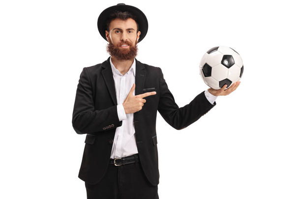 Bearded guy holding a football and pointing - Fotoğraf, Görsel