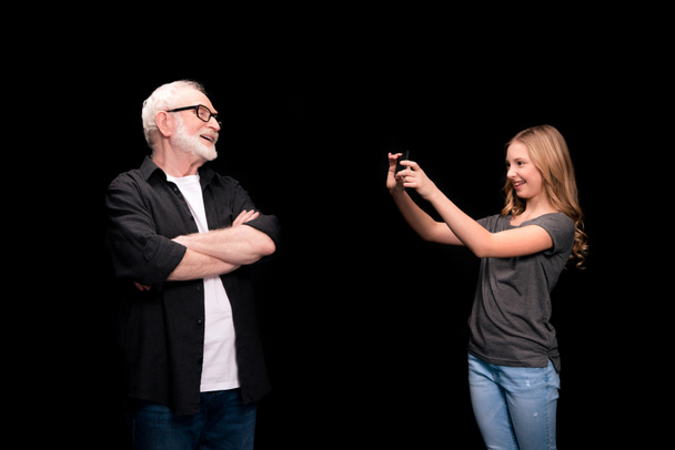 Grandfather and granddaughter with smartphone  - Photo, Image