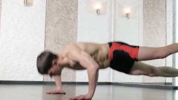 Man is engaged in trx exercises in the studio 4k - Záběry, video