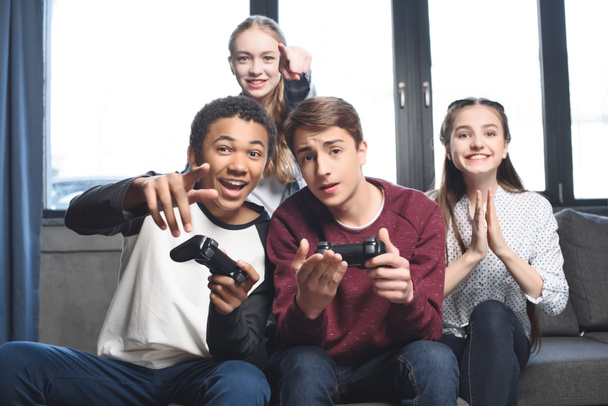 multicultural teenagers with joysticks - Photo, Image