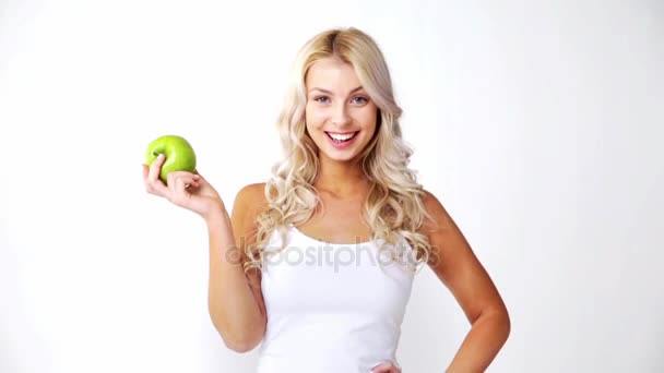 happy beautiful young woman with green apple - Video