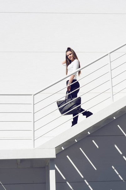 Urban young woman coming down the stairs  - Fotoğraf, Görsel