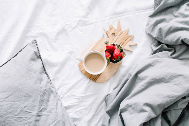 Breakfast in bed with coffee mug and strawberry - Photo, image