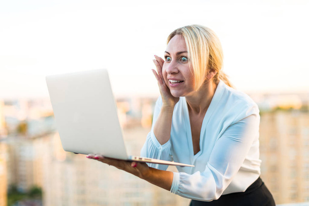 Femme d'affaires sur le toit avec ordinateur portable
  - Photo, image