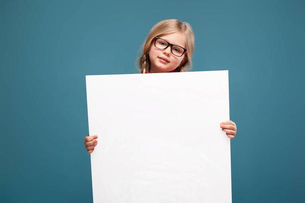 Girl holds empty poster - Фото, изображение