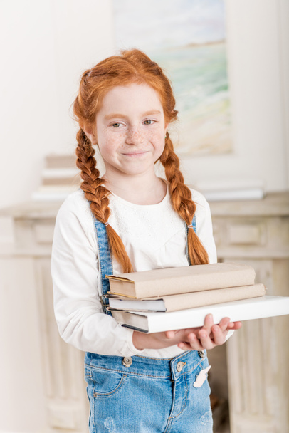 Little girl with books  - Фото, зображення