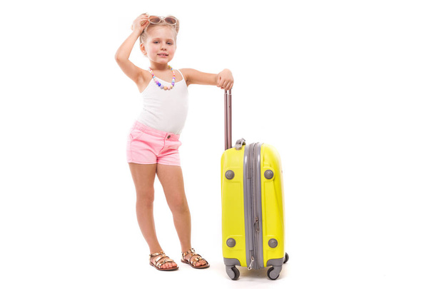 Little blonde girl with yellow suicase - Photo, Image