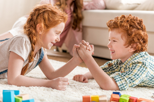 brother playing arm wrestling with sister - Photo, image