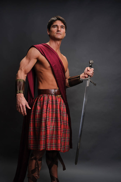 De liefdevolle highlander toont zijn spieren - Foto, afbeelding