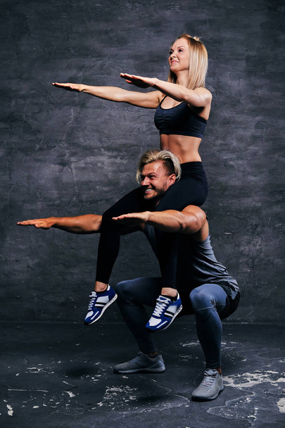 Athletic male doing squats with female - Photo, Image