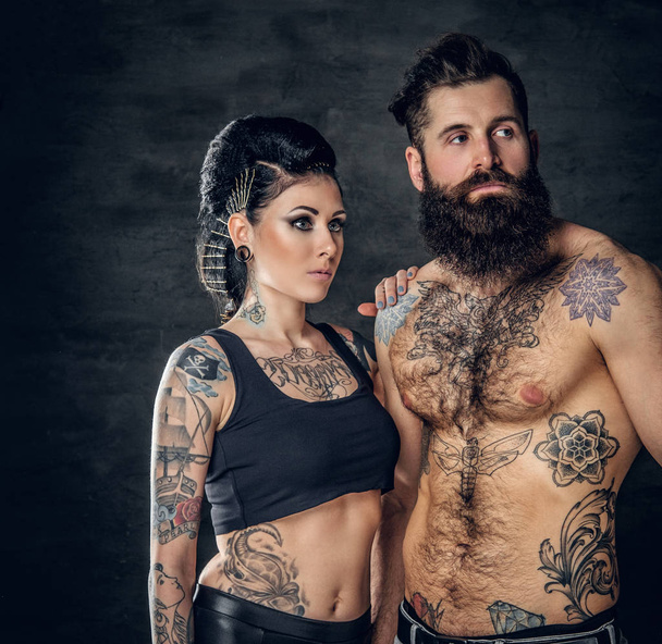 Studio portrait of tattooed couple - Photo, Image