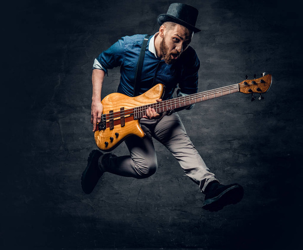 Funny bass player in a jump  - Photo, Image