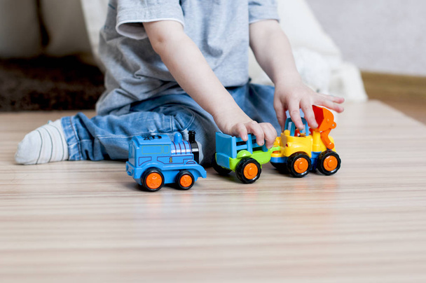 Child playing with toy cars - Фото, изображение