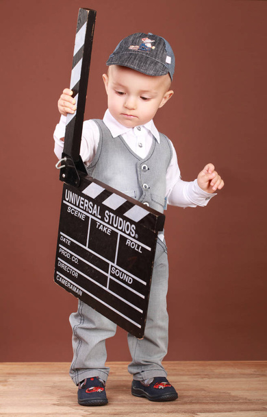 Cute little boy with cinema clapper - Foto, afbeelding