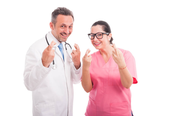Joyful medical team indicate good luck sign - Foto, Imagen