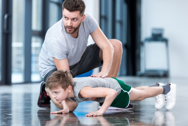 Boy doing push ups with coach - Photo, Image