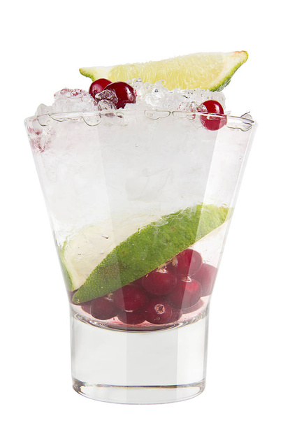 Vodka with ice, cranberries and lime. Strong alcoholic drink on a white background - Photo, image