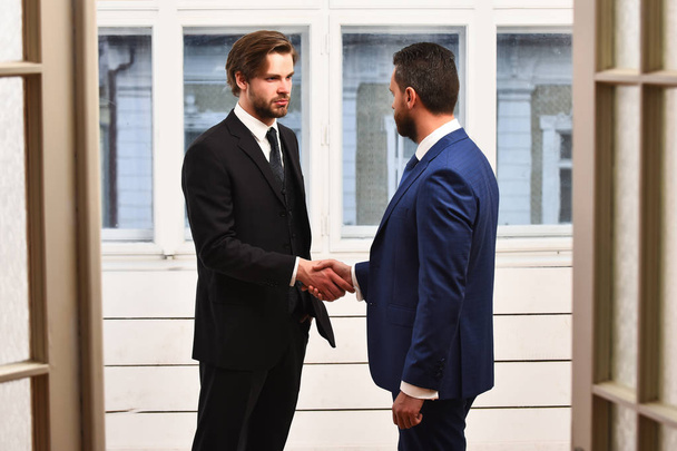 Two business partners shaking hands each other - Фото, изображение