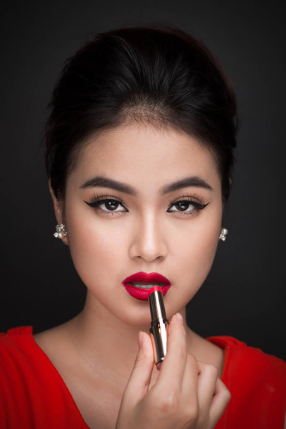 woman applying red lipstick.  - Fotó, kép