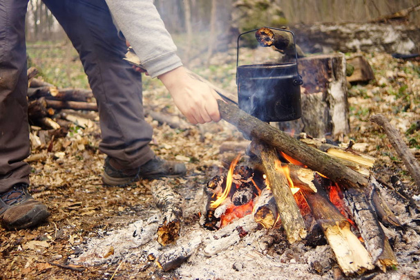 Preparing food on campfire in wild camping as - Valokuva, kuva