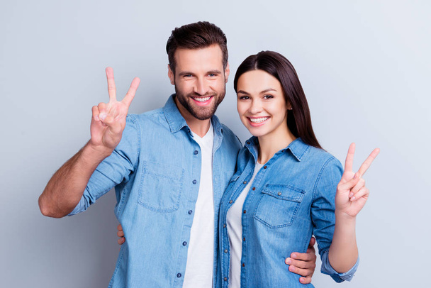 Photo of two young happy smiling people in jeans shirts isolated - Foto, imagen
