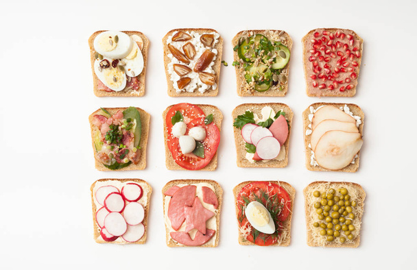 Assorted sandwiches on white background - Foto, afbeelding
