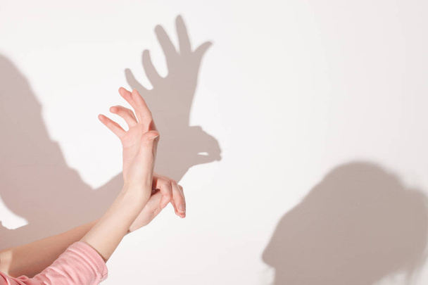shadows from the hand on white wall - Фото, зображення