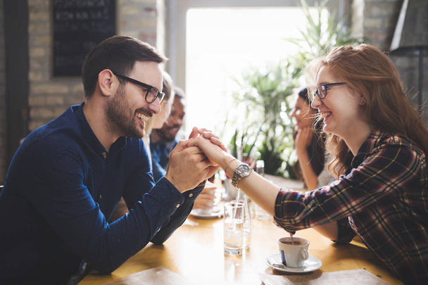 Flirting coworkers dating in restaurant - Foto, Imagen