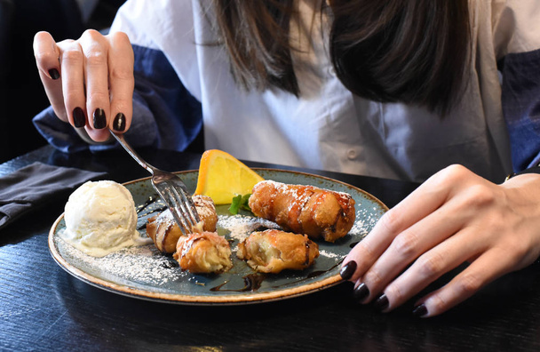 Young woman's hands holding a fork ready for eating a beautifully served dessert   - Foto, imagen