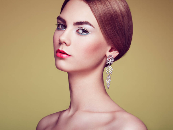 Fashion portrait of young beautiful woman with jewelry - 写真・画像