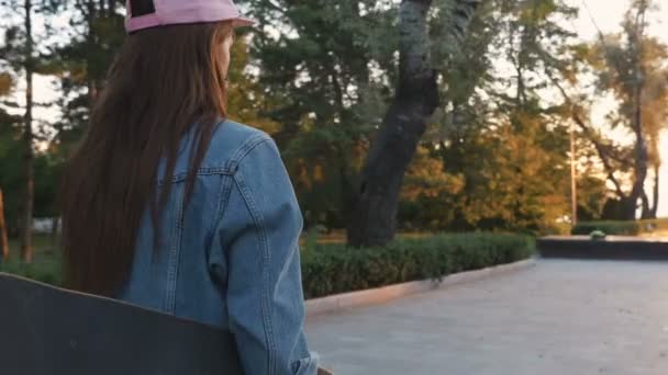fashion woman with longboard at park  - Filmati, video