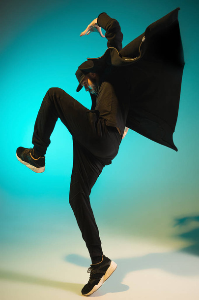 The silhouette of one hip hop male break dancer dancing on colorful background - Fotoğraf, Görsel