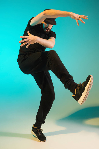 The silhouette of one hip hop male break dancer dancing on colorful background - Φωτογραφία, εικόνα