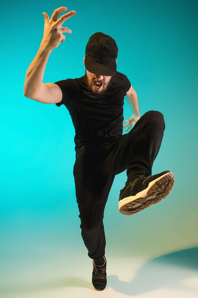 The silhouette of one hip hop male break dancer dancing on colorful background - Zdjęcie, obraz