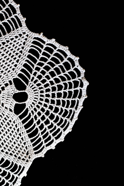 Handmade, white crochet, embroidery, on a black background, cont - Photo, Image