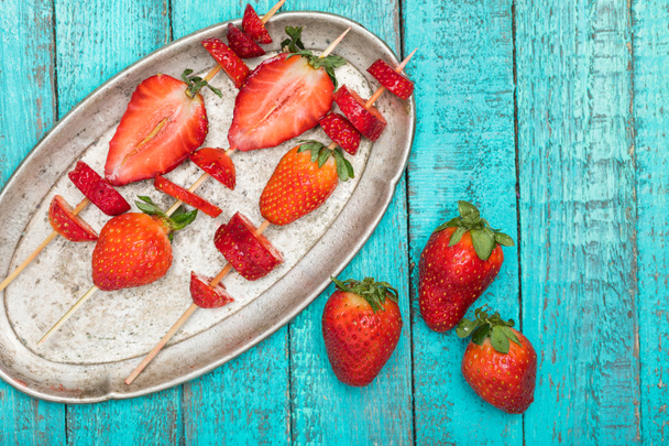 strawberries on wooden skewers - Foto, Bild