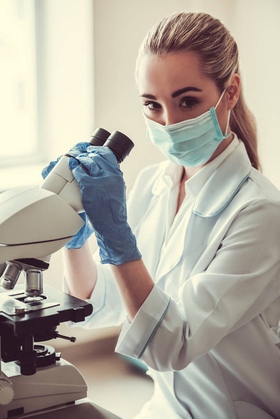 Beautiful female doctor in laboratory - Photo, Image