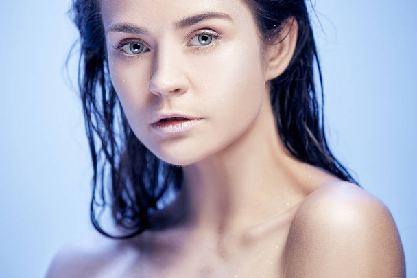 Beautiful woman face portrait close up on blue - Fotografie, Obrázek